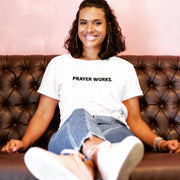 "Prayer Works." White t-shirt with black print; unisex