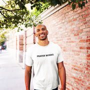 "Prayer Works." White t-shirt with black print; unisex